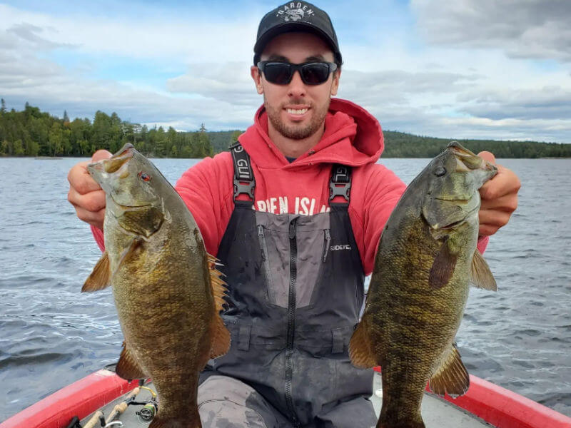 Guide Evan holding up two nice smallmouth bass.
