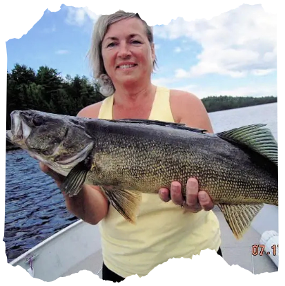 Woman Holding walleye on boat on Lady Evelyn Lake.