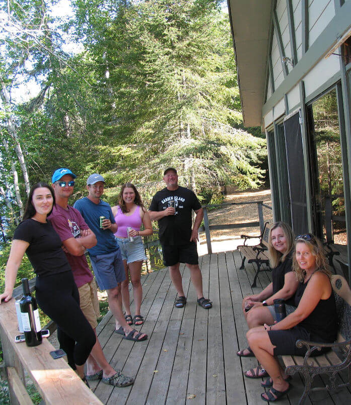 Large group on deck enjoying tales of the fishing outside main lodge.