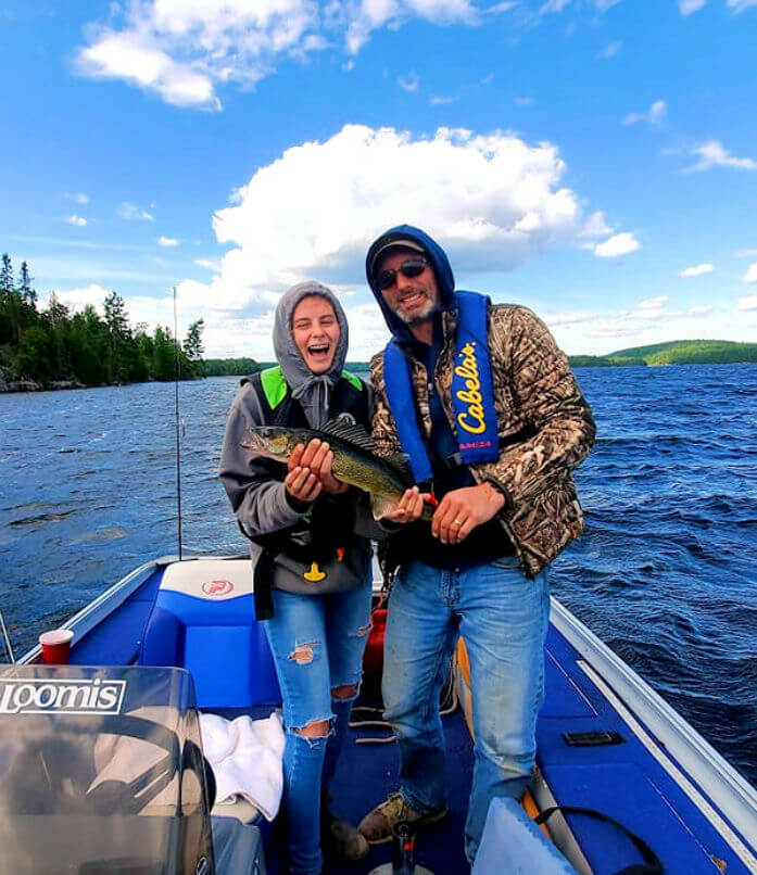 Happy anglers holding beautifully colored trophy Ontario walleye.