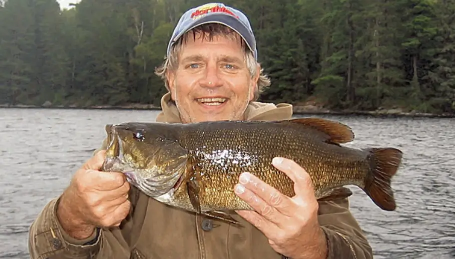 Garden Island Lodge angler holding a nice sized smallmouth bass.