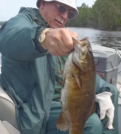 Garden Island Lodge American Plan angler holding up a nice smallmouth bass before releasing it.