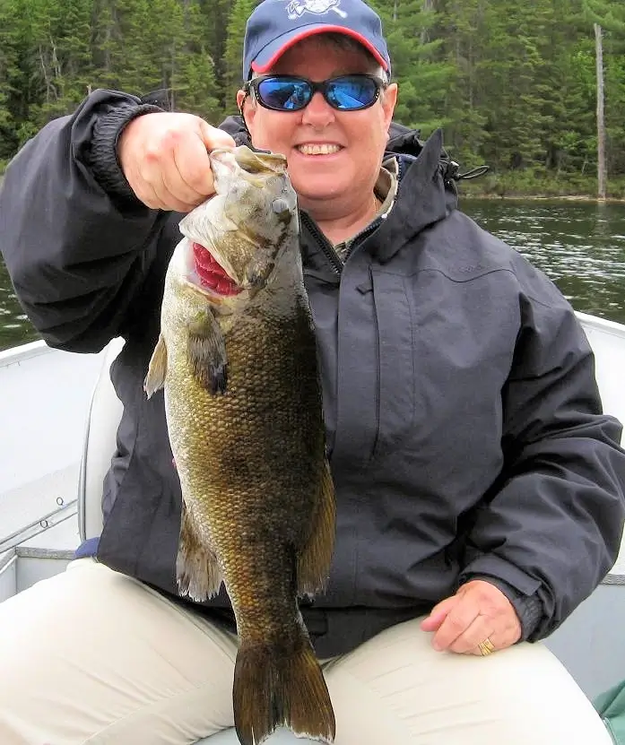 Garden Island Lodge American Plan angler displays a nice smallmouth bass before releasing it on Lady Evelyn Lake.