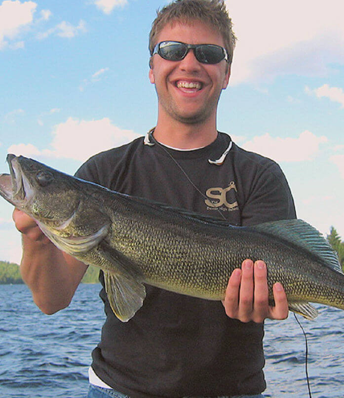Young angler holding large 30 inch Ontario walleye.